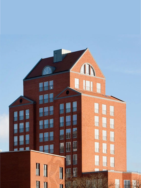 A tall brick building with a large window.